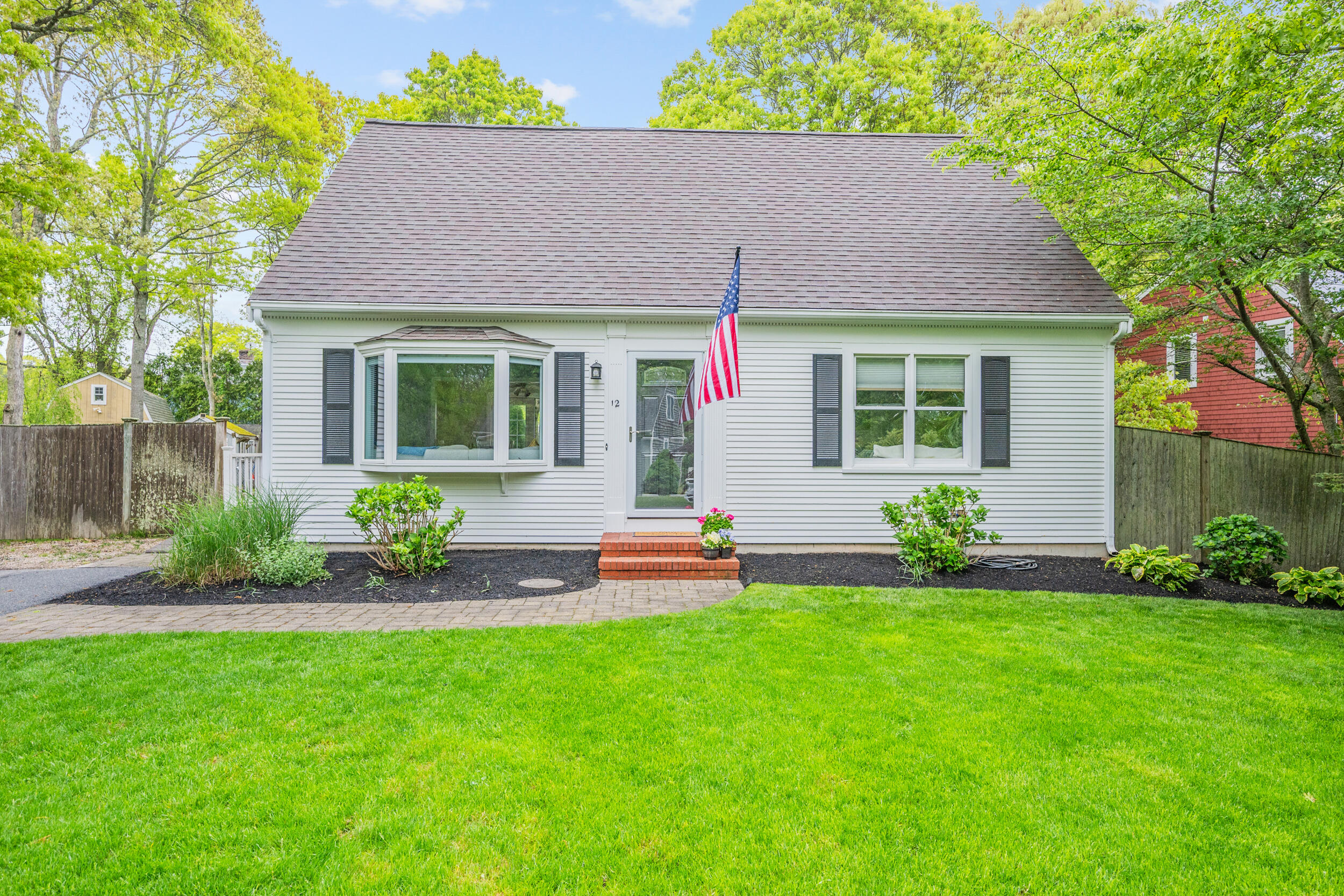 12 Anthony Drive Hyannis, MA 02601 - Photo 3 of 34 a front view of a house with a garden and plants