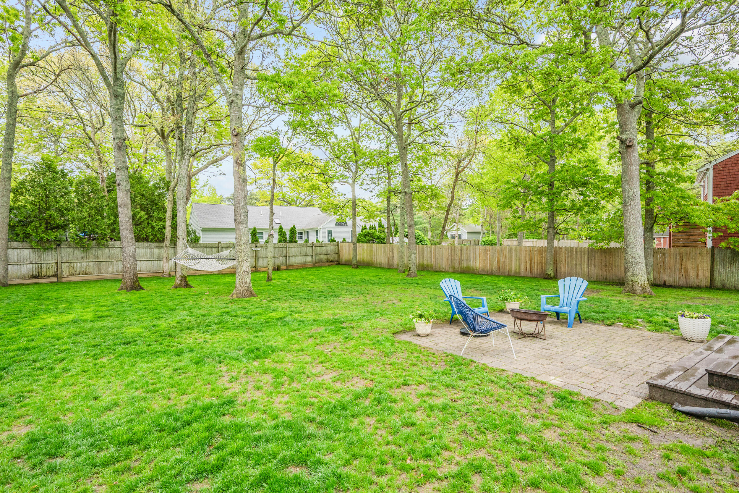 12 Anthony Drive Hyannis, MA 02601 - Photo 34 of 34 a view of backyard with table and chairs and a large tree