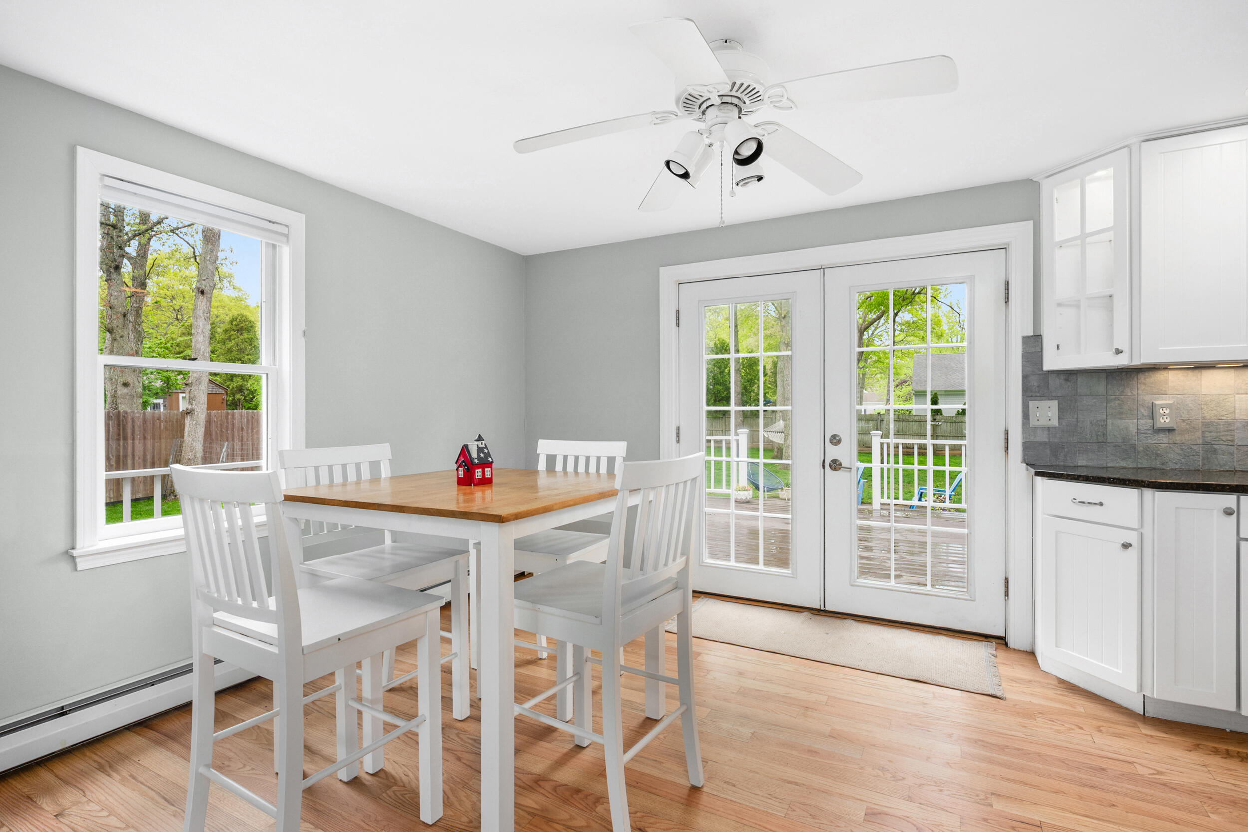 12 Anthony Drive Hyannis, MA 02601 - Photo 8 of 34 a dining room with wooden floor a chandelier a wooden table and chairs