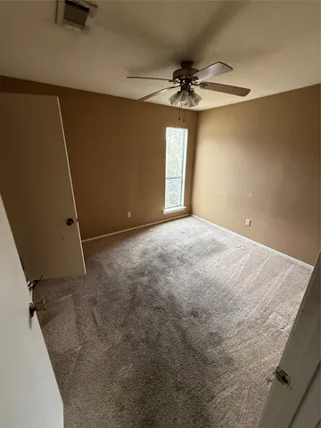 a view of a livingroom with a ceiling fan and window