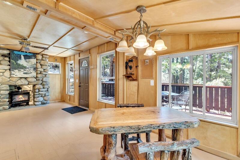 27240 Saunders Meadow Road Idyllwild, CA 92549 - Photo 21 of 51 a dining room with furniture and a chandelier