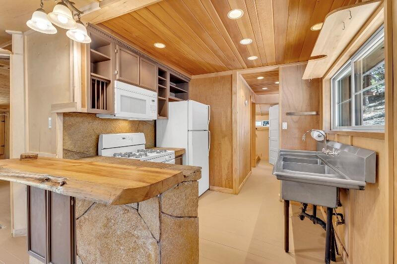27240 Saunders Meadow Road Idyllwild, CA 92549 - Photo 22 of 51 a view of residential kitchen with dining room and wooden furniture