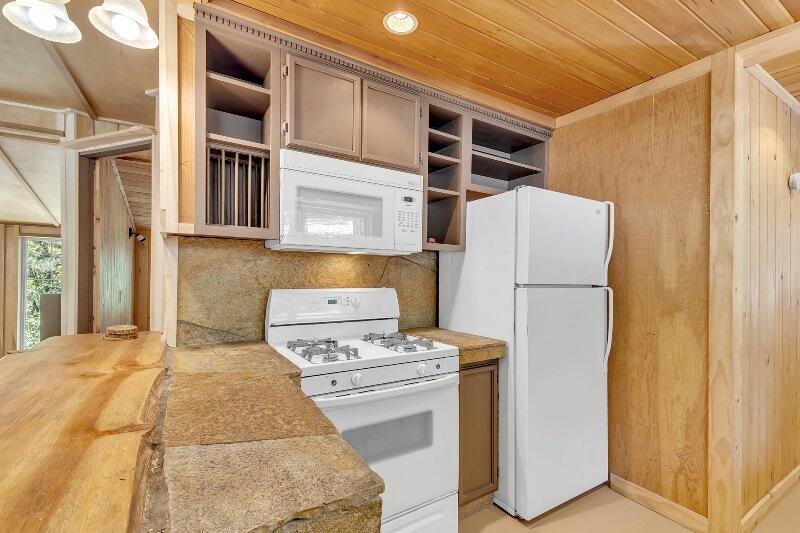 27240 Saunders Meadow Road Idyllwild, CA 92549 - Photo 25 of 51 a bedroom with a bed and a refrigerator