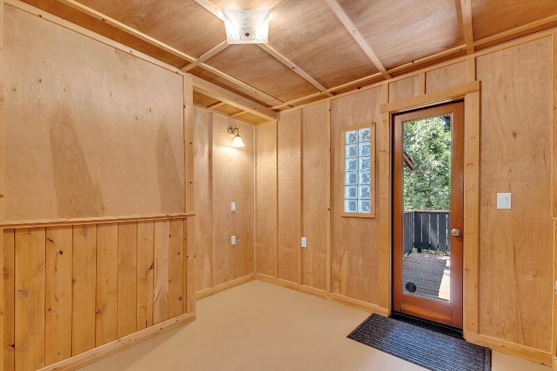 27240 Saunders Meadow Road Idyllwild, CA 92549 - Photo 32 of 51 a view of an empty room with wooden floor and a window