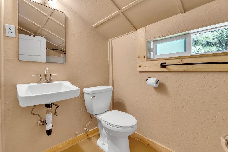 27240 Saunders Meadow Road Idyllwild, CA 92549 - Photo 35 of 51 a bathroom with a sink a toilet and mirror