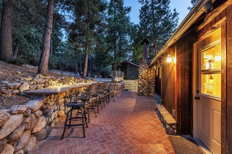 27240 Saunders Meadow Road Idyllwild, CA 92549 - Photo 46 of 51 a view of a patio with table and chairs and potted plants