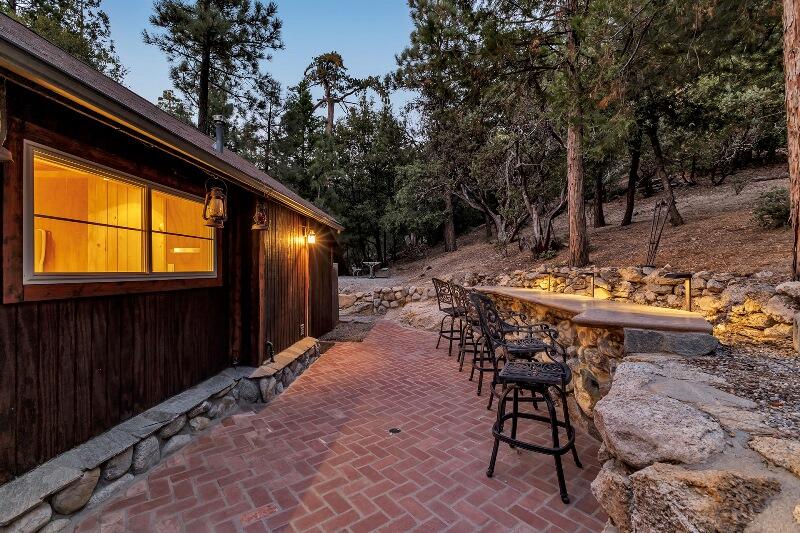 27240 Saunders Meadow Road Idyllwild, CA 92549 - Photo 47 of 51 a backyard of a house with table and chairs