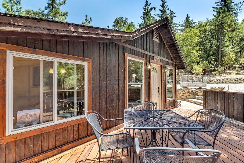 27240 Saunders Meadow Road Idyllwild, CA 92549 - Photo 8 of 51 a view of a patio with a table chairs and a small yard