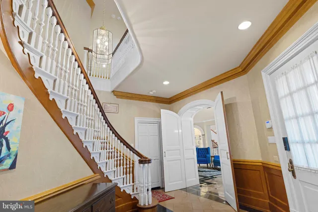 a view of a hallway with wooden floor and stairs
