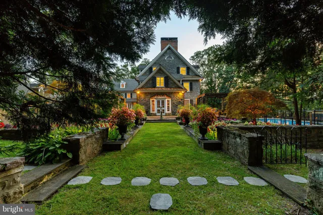 a front view of a house with yard and green space