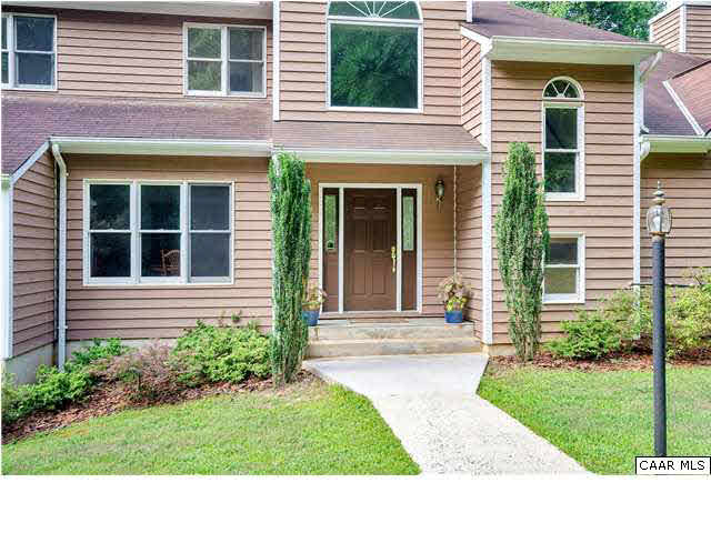 121 Vincennes Road Charlottesville, VA 22911 - Photo 3 of 42 a view of a house with brick walls and a yard with plants