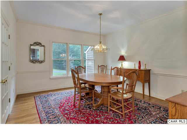 121 Vincennes Road Charlottesville, VA 22911 - Photo 6 of 42 a dining room with furniture a rug and a chandelier