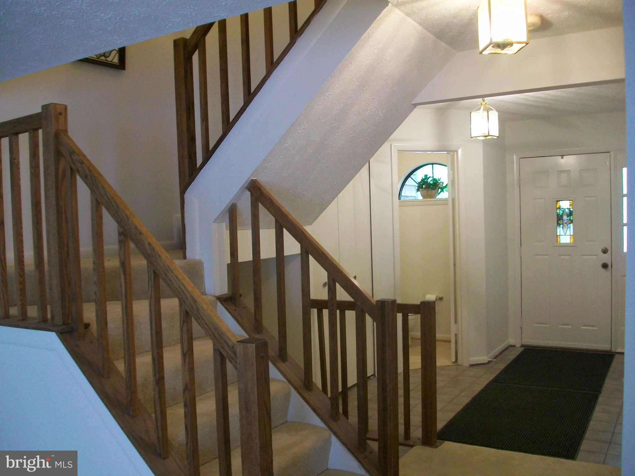 6344 Red Haven Road Columbia, MD 21045 - Photo 4 of 14 a view of staircase with lots of frames on wall and wooden floor