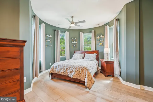 a bedroom with a large bed and a large window