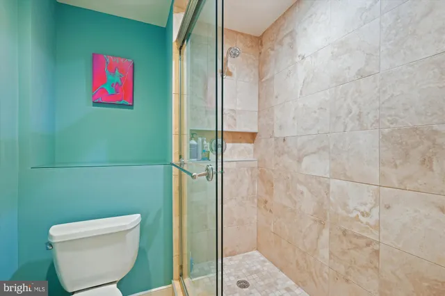 a bathroom with a toilet and a shower