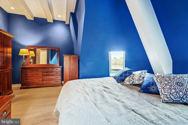 a bed room with a bed and dresser