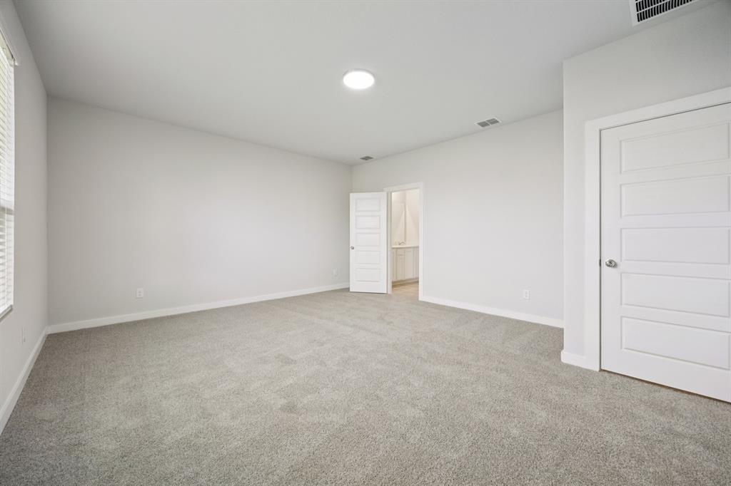 7624 Kingfisher Road Aubrey, TX 76227 - Photo 15 of 32 a view of an empty room and a window