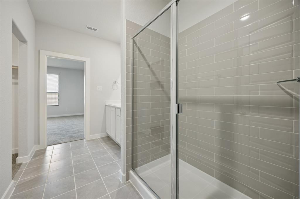 7624 Kingfisher Road Aubrey, TX 76227 - Photo 19 of 32 a bathroom with a shower