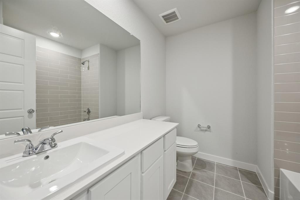 7624 Kingfisher Road Aubrey, TX 76227 - Photo 24 of 32 a bathroom with a sink a toilet and shower