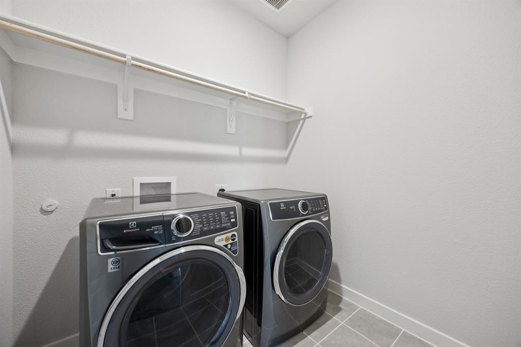 7624 Kingfisher Road Aubrey, TX 76227 - Photo 27 of 32 a utility room with dryer and washer