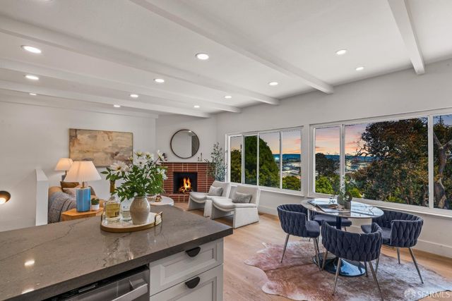 a living room with furniture potted plant floor to ceiling window and potted plants