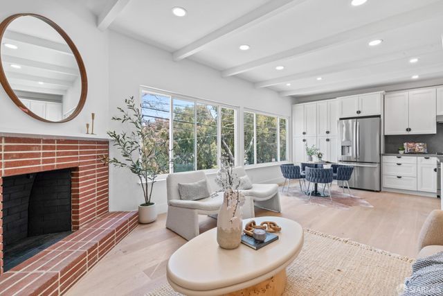 a view of a livingroom with a potted plant and a fireplace