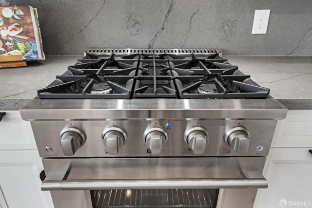 a kitchen with white cabinets and stainless steel appliances