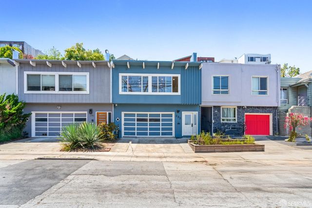 a front view of a house with a yard and a garage