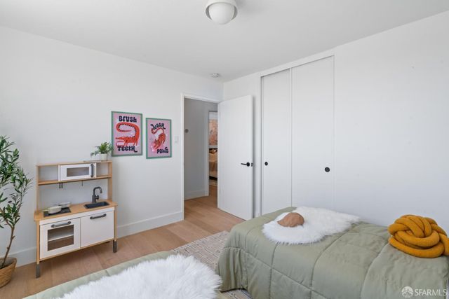 a bedroom with a bed and a potted plant