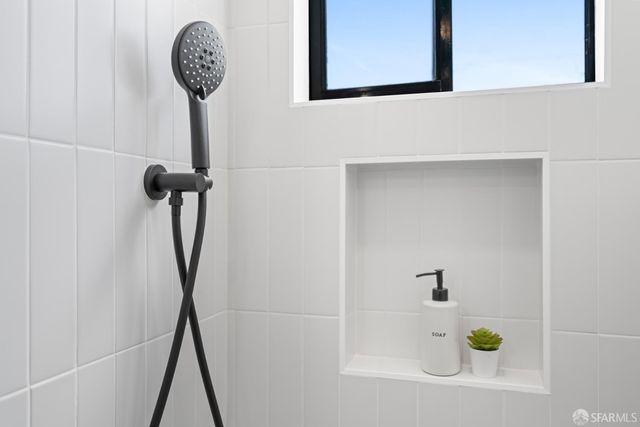a view of a backyard with table and chairs potted plants and wooden fence
