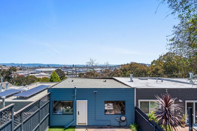a view of a street with potted plants