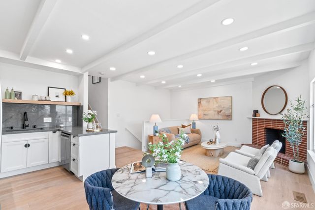 a living room with furniture a fireplace and a bookshelf