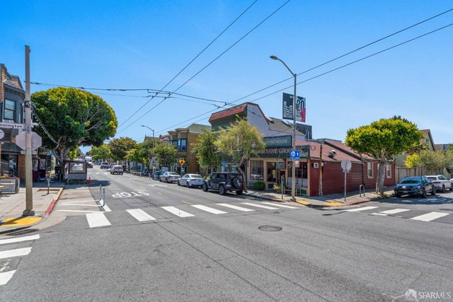 an aerial view of residential houses with city view