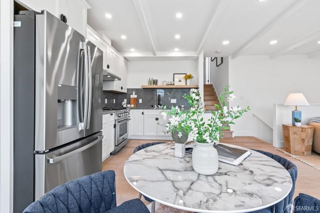 a living room with furniture a fireplace a rug and a large window