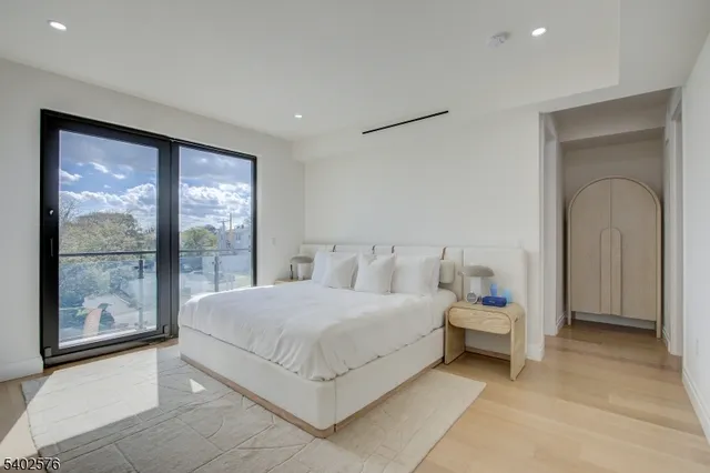 a bedroom with a bed and a large window