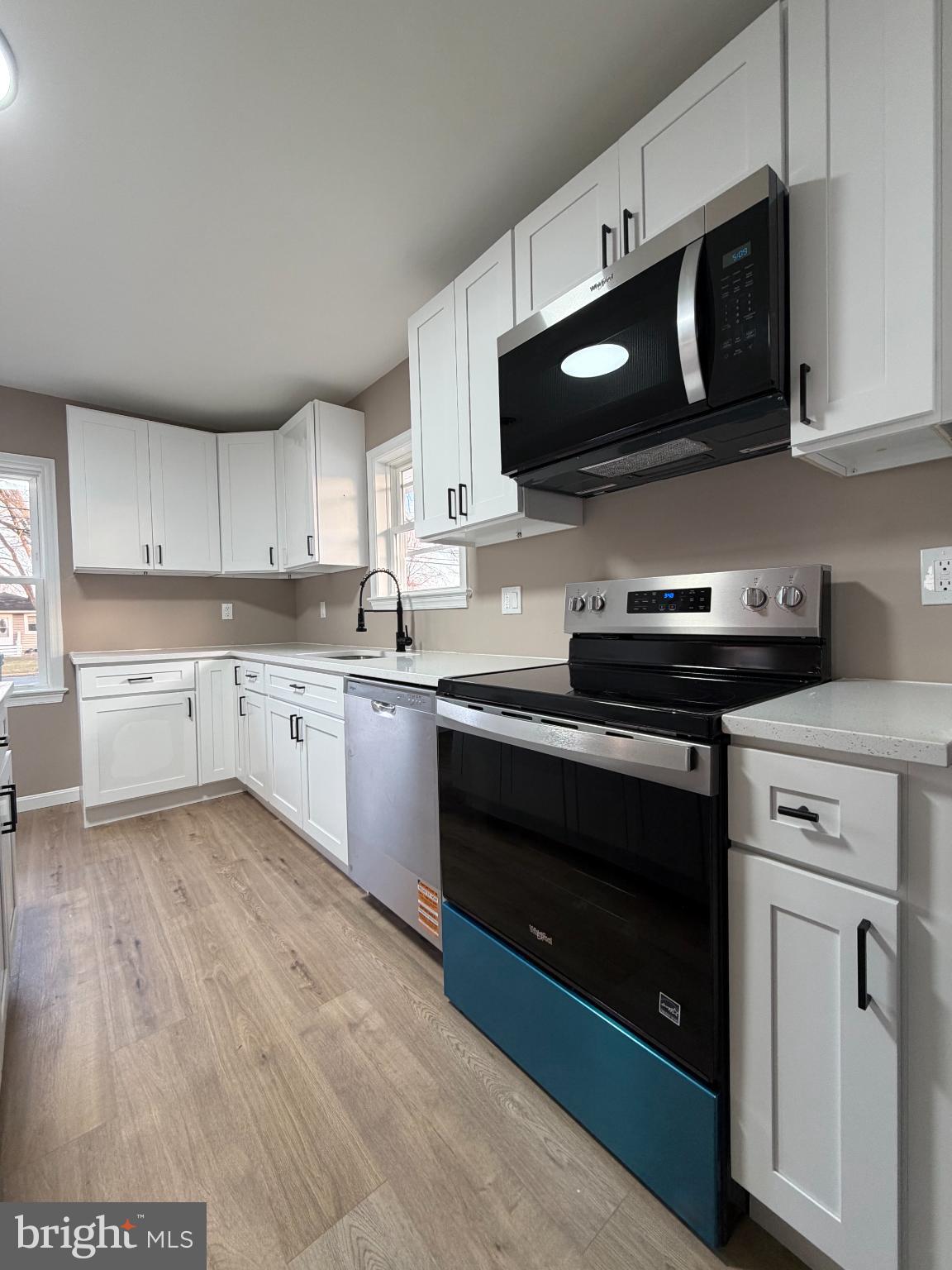 1906 Harbor Drive Chester, MD 21619 - Photo 12 of 44 a kitchen with stainless steel appliances a stove a microwave a sink and cabinets