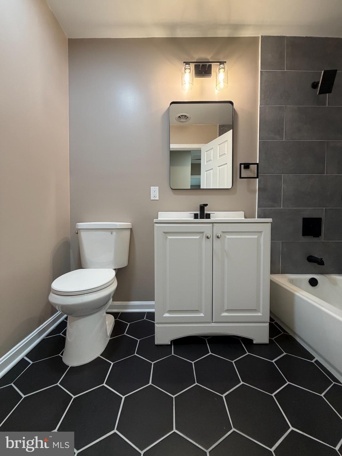 1906 Harbor Drive Chester, MD 21619 - Photo 22 of 44 a bathroom with a toilet a sink and mirror