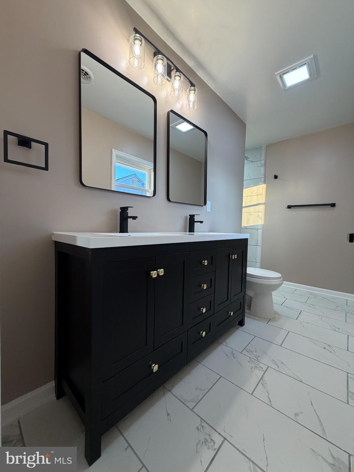 1906 Harbor Drive Chester, MD 21619 - Photo 33 of 44 a bathroom with a double vanity sink and a mirror