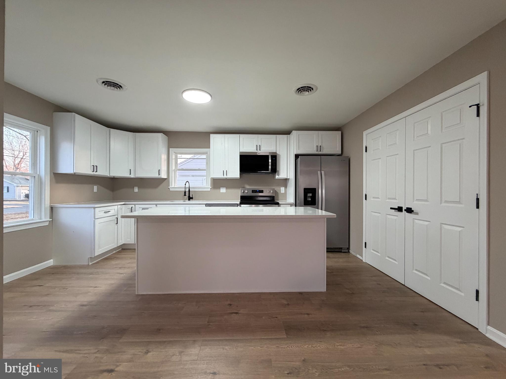 1906 Harbor Drive Chester, MD 21619 - Photo 6 of 44 a view of kitchen with granite countertop a stove top oven a sink and a microwave