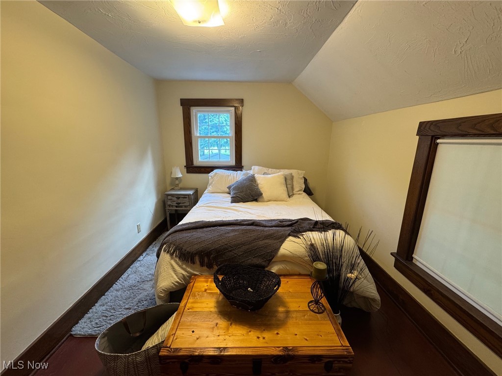 5322 Lockwood Road Madison, OH 44057 - Photo 26 of 30 Bedroom featuring a lofted ceiling and wood floor