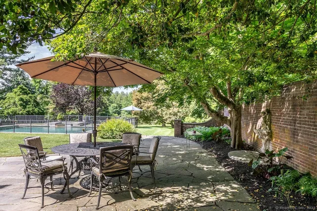 a view of backyard with seating space and trees
