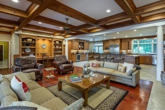 a living room with furniture and a view of kitchen