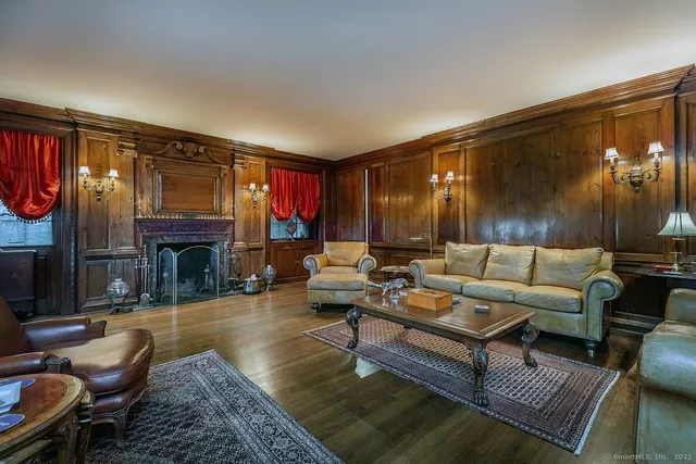 a living room with fireplace furniture and a fireplace