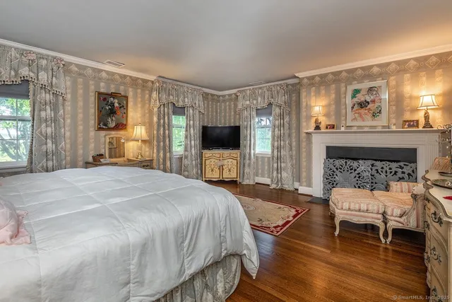 a spacious bedroom with a bed and a fireplace