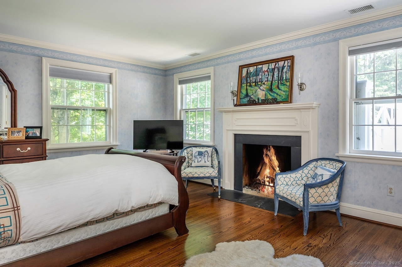 19 Seherr Thoss Drive Litchfield, CT 06759 - Photo 28 of 37 a bedroom with a bed and a fireplace