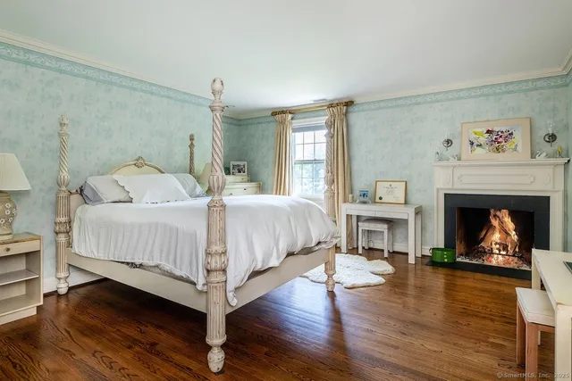 a bedroom with a bed and a fireplace