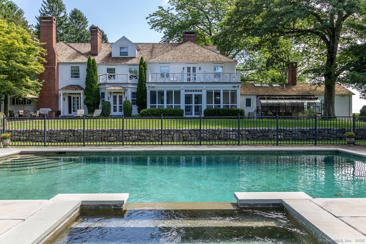 19 Seherr Thoss Drive Litchfield, CT 06759 - Photo 3 of 37 a view of a house next to a lake with a large trees