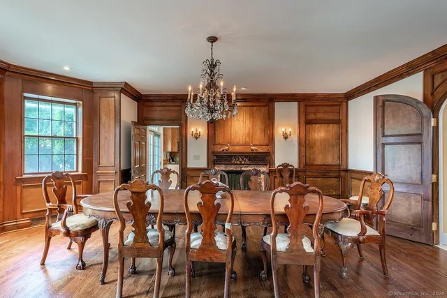 a view of a dining room with furniture and chandelier