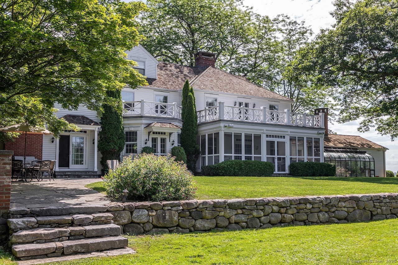 19 Seherr Thoss Drive Litchfield, CT 06759 - Photo 9 of 37 a front view of a house with a garden and swimming pool