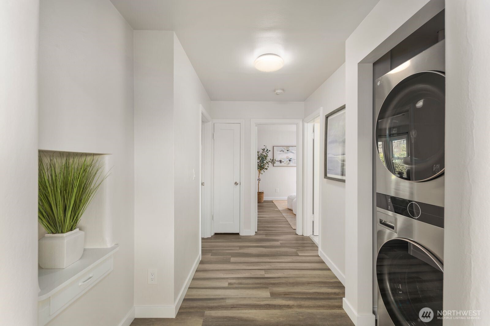 6023 35th Avenue Southwest Seattle, WA 98126 - Photo 15 of 38 a view of a hallway with wooden floor and dining room